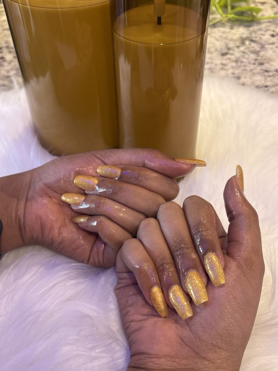 Long gold glitter coffin nails with a warm shimmer finish