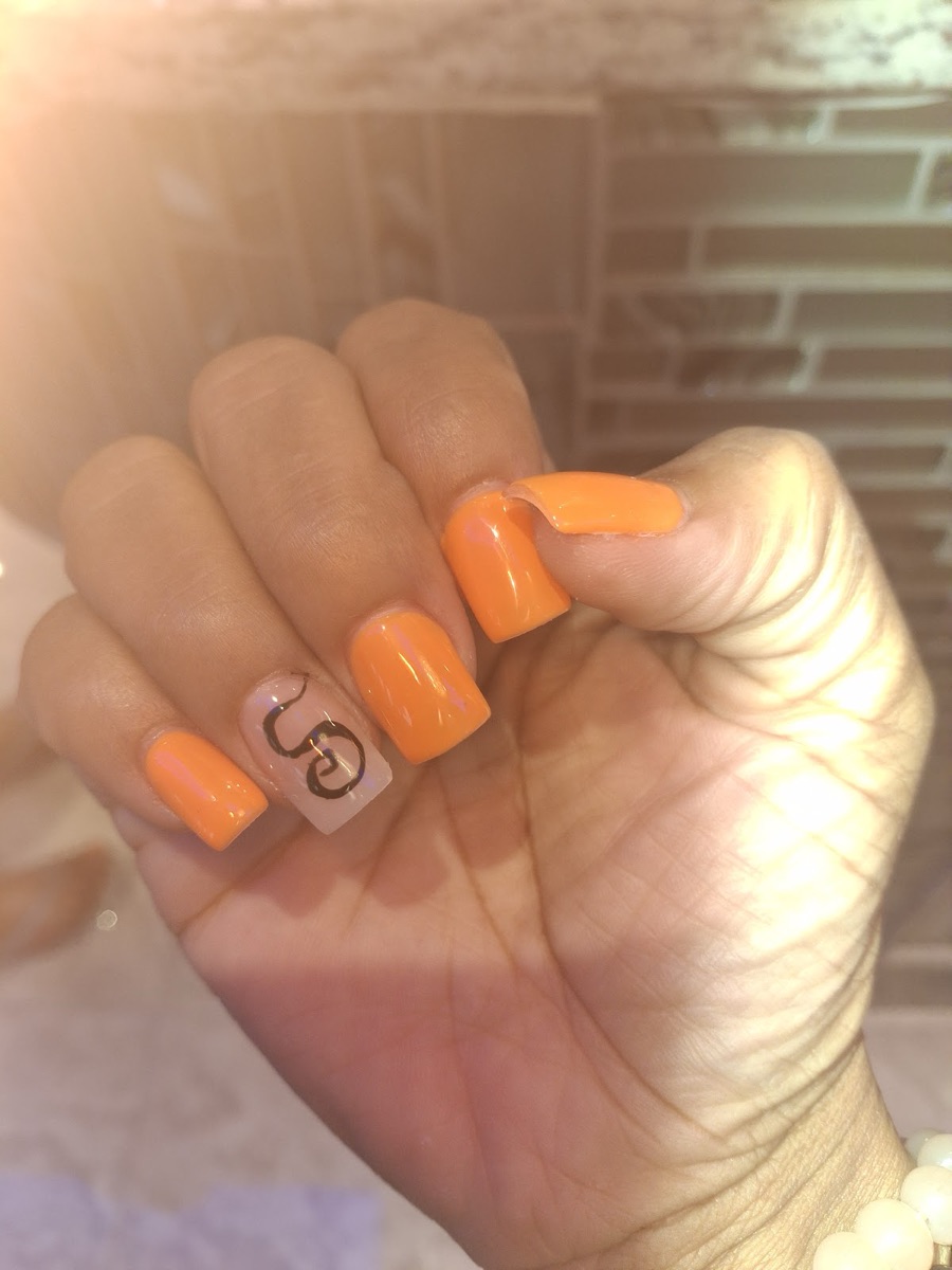 Bright orange square nails with a hand-painted accent