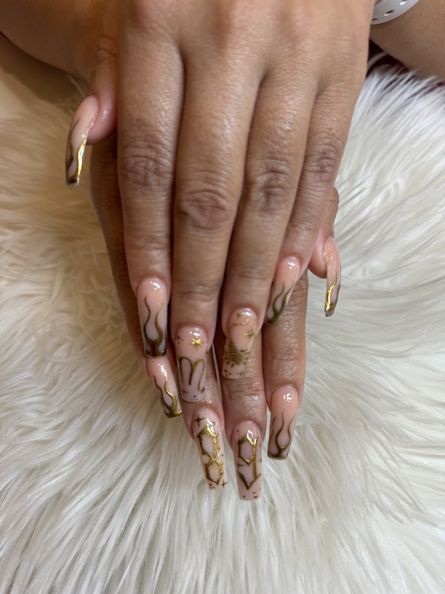 Nude nails with delicate hand-painted gold celestial nail art at US Nails in Decatur, GA