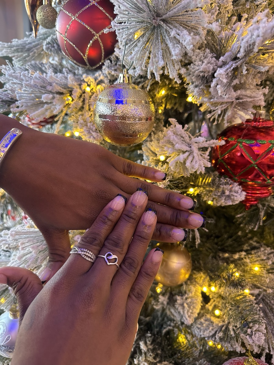 Glossy nude-pink nails styled by the holidays
